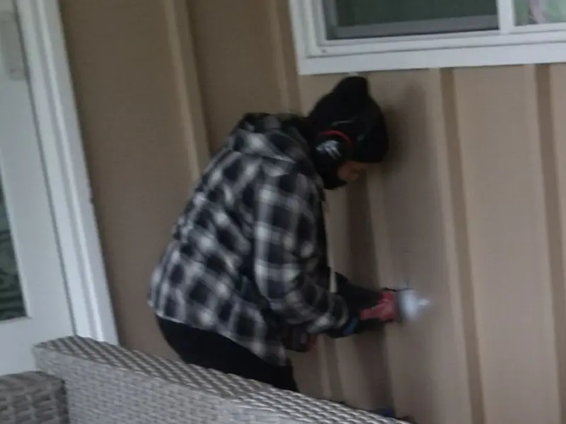 Professional electrician installing an exterior outlet in Decorah