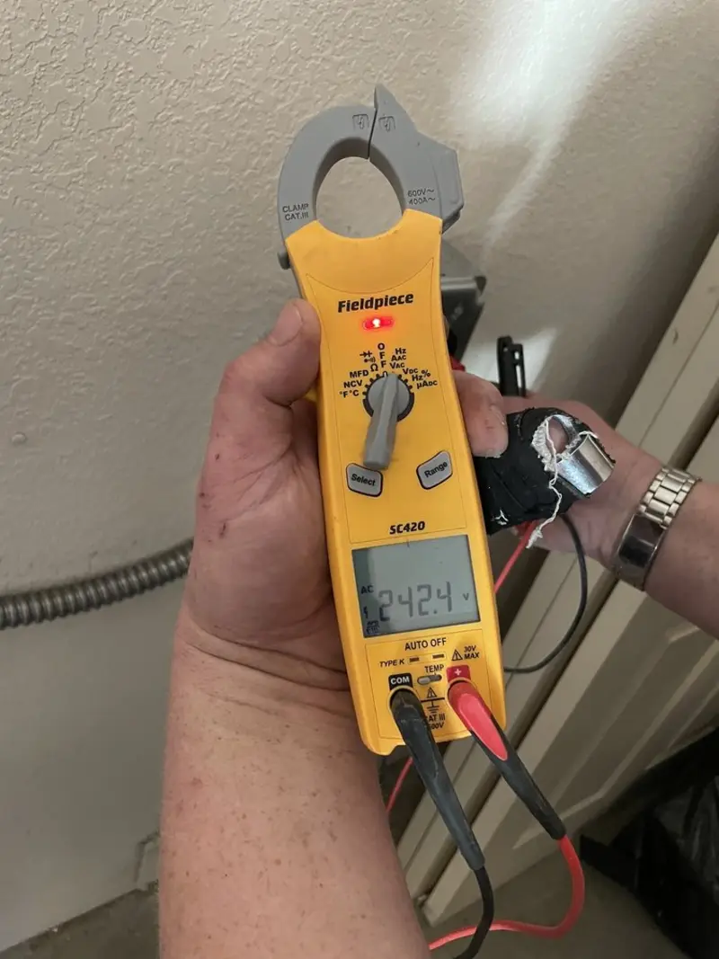 Voltage testing with clamp meter during Generator Installation in Decorah